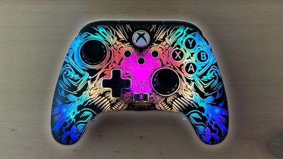 A black Xbox-style controller with multicolored Lumectra lighting on the front plate in a "ghost" pattern.